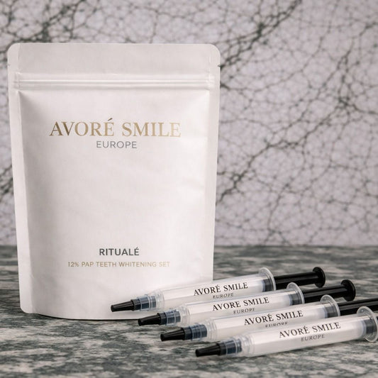 Avore Smile Europe teeth whitening set with 4 syringes, and the packet on a marble surface with a green marble background 